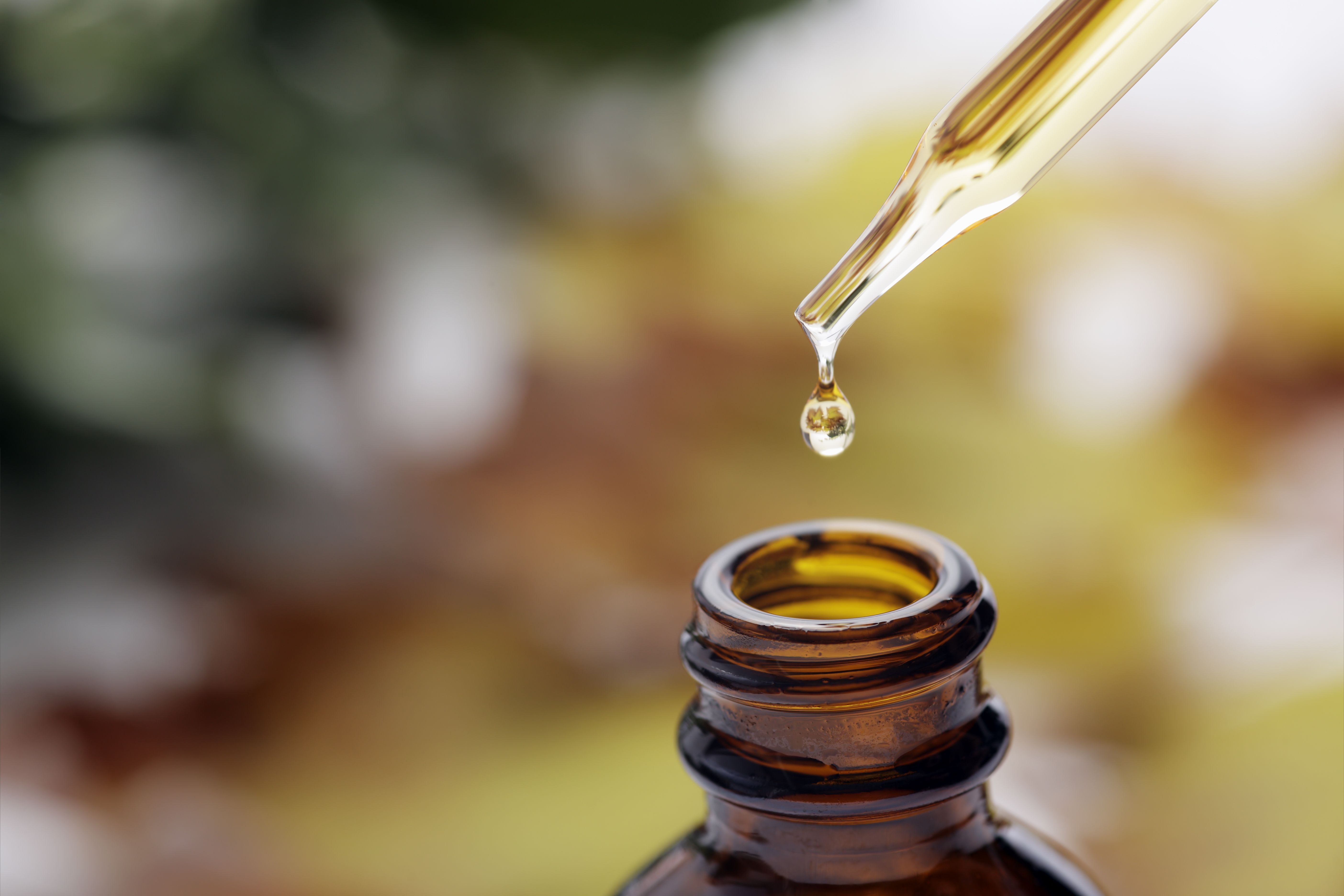 Glass bottle of essential oil with a dropper